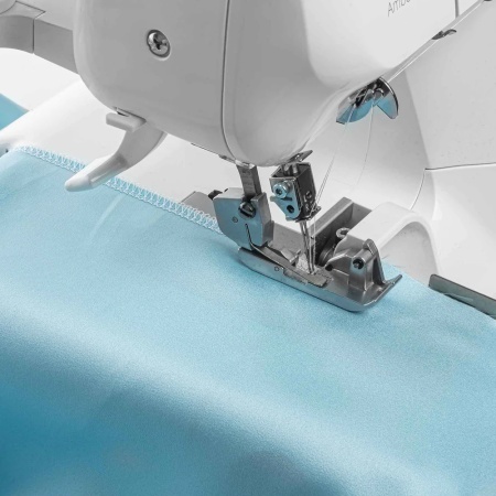 Sewist finishing fabric edge using the Husqvarna Amber S100 overlocker.