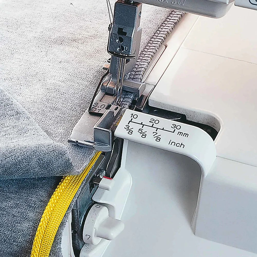 Close-up of the Huskylock S21 overlocking some fabrics.