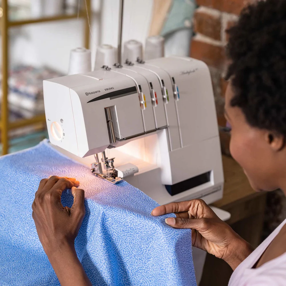 Huskylock S21 4-thread overlocker on a sewing table, ready for use.