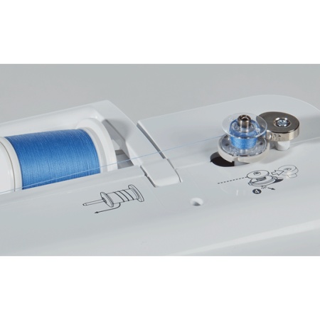 Thread spool area and bobbin being wound on sewing machine.,