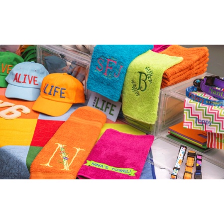 Collection of brightly coloured garments that have been embroidered using the Brother PR1 single needle embroidery machine