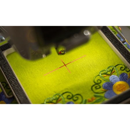 Close up of the design positioning feature, a red cross projected onto fabric on the PR1