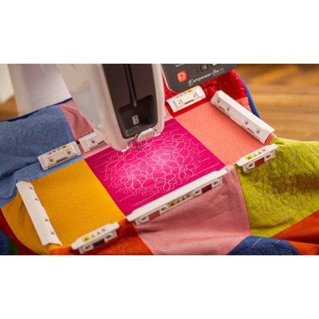 Close up of the PR1 embroidery machine with fabric in a hoop being embroidered.