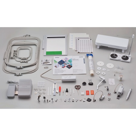 sewing machine accessories and embroidery frames laid out on a table