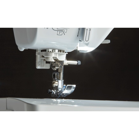 Sewing machine presser foot, hovering over the sewing plate.