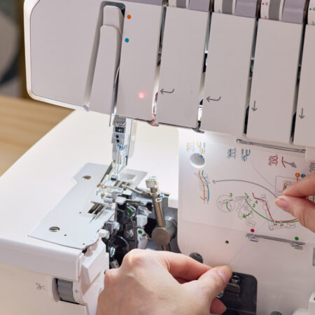 Close-up of HUSQVARNA VIKING Amber S 300 overlocker threading and looper area