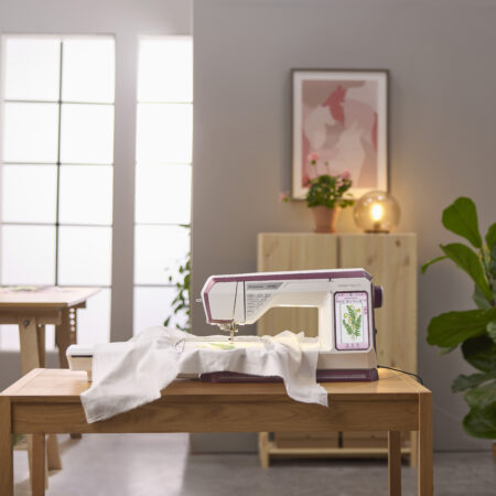 Lifestyle shot of the Designer Topaz sewing and embroidery machine
