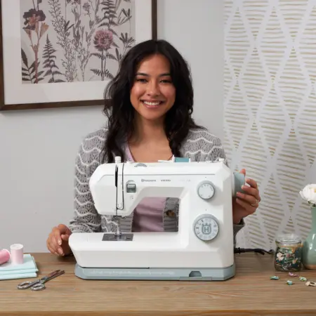 Angled view of Husqvarna Viking Onyx 15 sewing machine in use on fabric