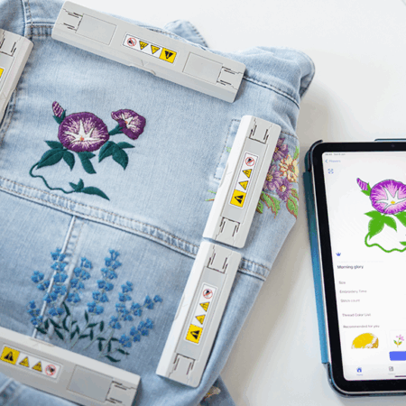 Magnetic frame with embroidery and tabelt/phone displaying the Brother Artspira app in use